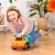Pojazd budowlany Wonder Wheels B.toys bezpieczny dla roczniaka bawiąca się dziewczynka
